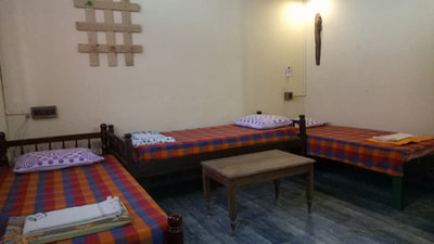 dormitory room with 4 single beds and 1 futon bed comes with ensuite toilet, basic kitchen, private patio, hot and cold water, free wifi